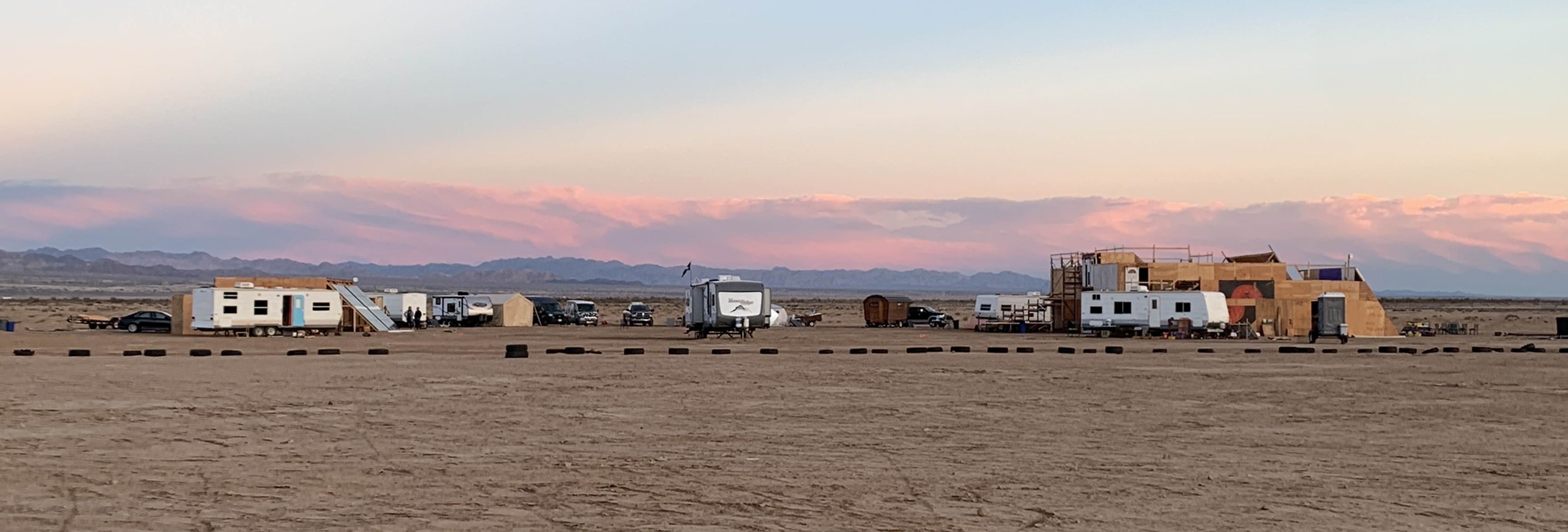 A wide shot of the Freeside settlement in the desert at dusk.